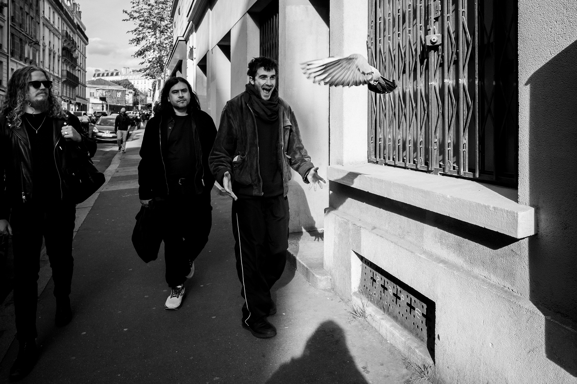 Black and white photo of the three members of DARKSIDE walking in the streets of an urban environment